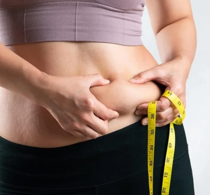 Measuring tape around the waist, the weight management goal AlkaBurn targets